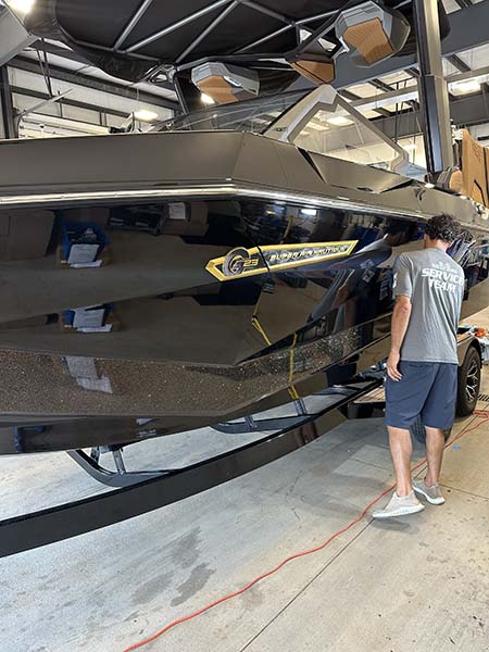 A technician working on a boat detailing.