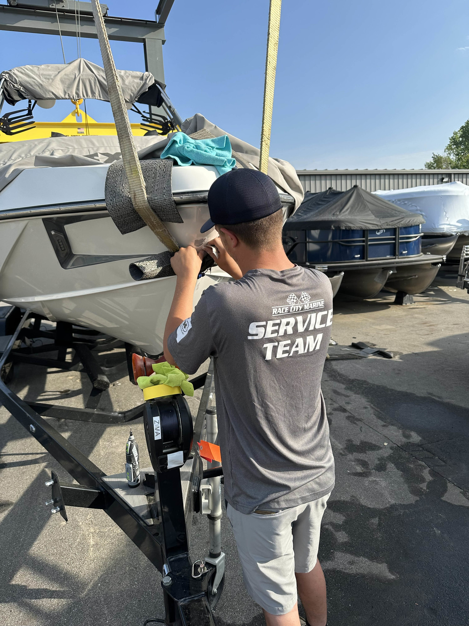 A technician working on gelcoat repair with close-up detail of the repair process.